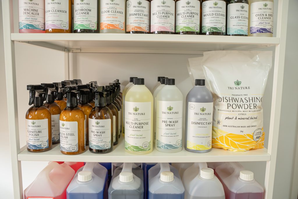 Shelves stocked with Tri Nature eco-friendly cleaning products in a cleaning facility