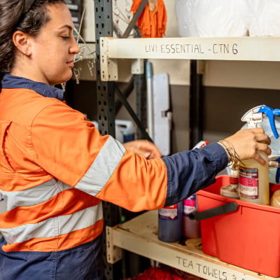 Kestrel Cleaning team member organizing cleaning supplies in storage